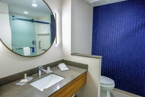 A modern bathroom with a large mirror, a sink, and a toilet. - Fairfield Inn & Suites by Marriott Scranton Montage Mountain (Moosic)