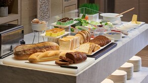 A buffet with various breads, pastries, and salads. - Fairfield by Marriott Bintulu Paragon (Bintulu)