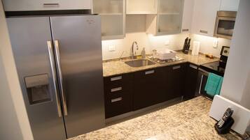 Fridge, microwave, coffee/tea maker, cookware/dishes/utensils