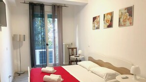 A hotel room with a bed, a small bedside table, a chair, a window with curtains, and three framed pictures on the wall. - Venice Romantic Views Ca' Crea (Venice)