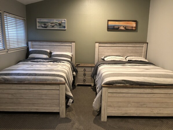 A bedroom with two wooden beds, a nightstand, and a window with blinds. - Fish,Drink,Eat,Party right of your private balcony!<br>Ski and boat rental at marin (Willis)