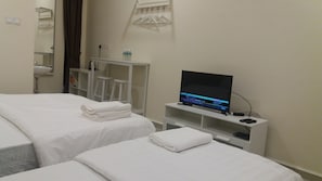A hotel room with two beds, a TV, a small table, and a mirror. - GLG KLIA Transit House (Sepang)