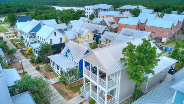 A residential area with a variety of house styles, including single and multi-story homes with different roof materials and colors. - Carlton Landing! Charming Cottage on boardwalk! (Carlton Landing)