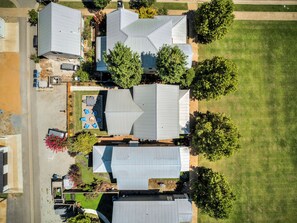 Residential homes surrounded by lush greenery and trees, offering ample outdoor space for relaxation and socializing.