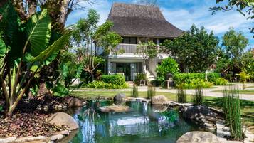 Surrounded by lush greenery and a serene pond, this tranquil retreat offers a peaceful escape.