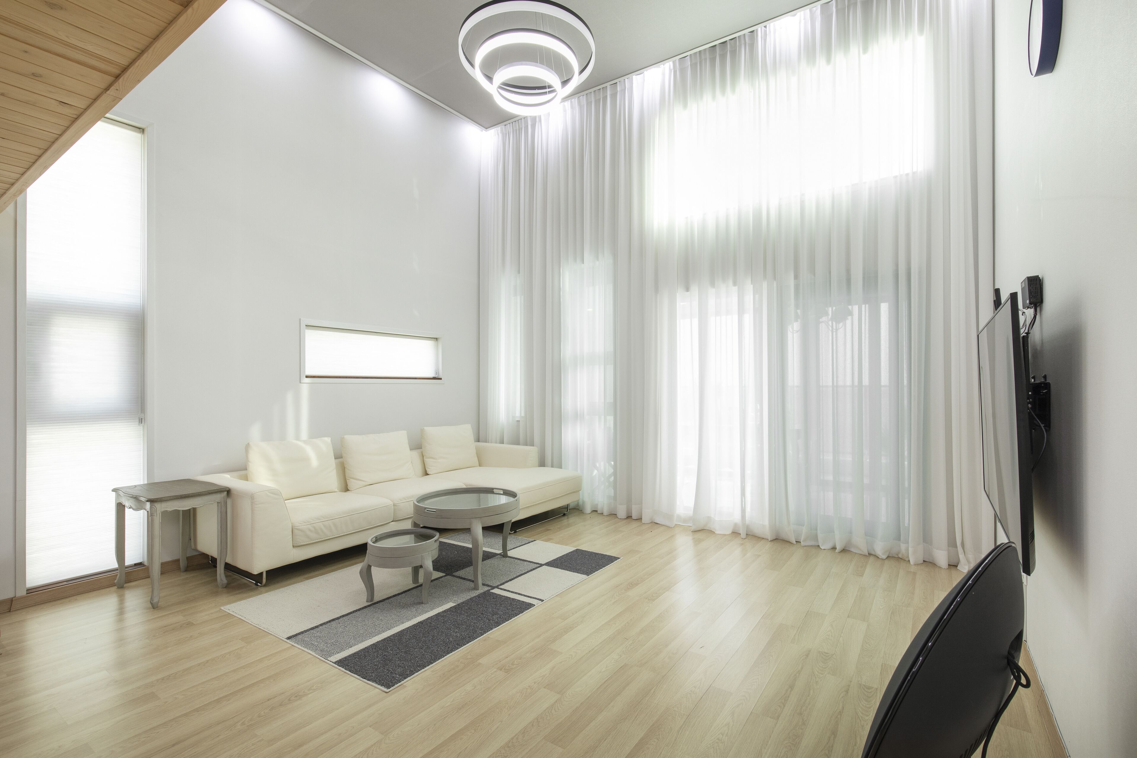 A modern living room with a sofa, coffee table, and TV.
