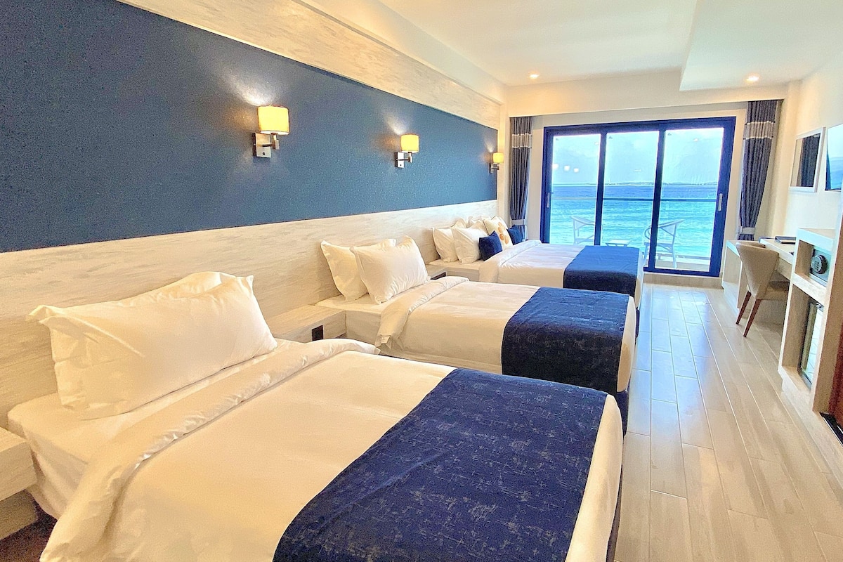 deluxe quadruple room, balcony, sea view | 1 bedroom, minibar, in-room safe, individually furnished
