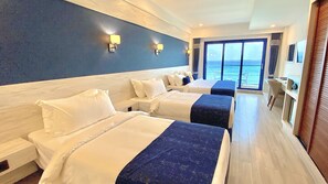 A hotel room with two beds, a desk, and a view of the ocean. - Kaani Palm Beach (Maafushi)
