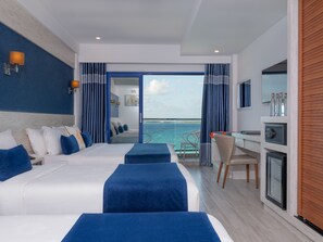 A hotel room with two beds, a desk, a chair, and a view of the ocean. - Kaani Palm Beach (Maafushi)