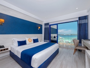 Una habitación de hotel moderna con una cama grande, un escritorio y vista al mar.