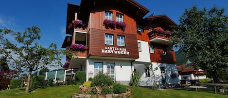A multi-story building with a sign reading 'Gastehaus Hartweger.'