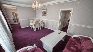 A room with a purple carpet, a white table, and purple upholstered chairs. - Hotel Orto-Asia (Osh)