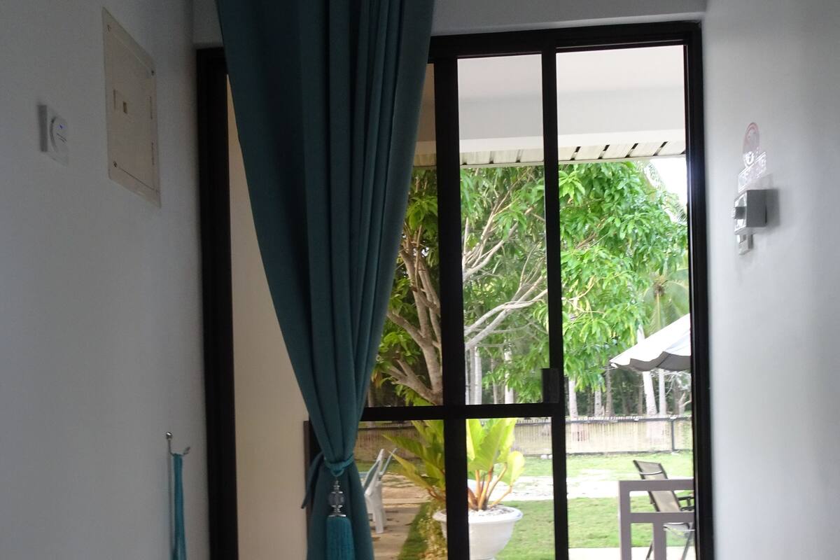 A room with a sliding glass door leading to a patio.