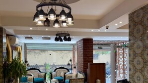 A spacious lobby with patterned walls, a large chandelier, and comfortable seating areas. - New Star Zamalek Hotel (Cairo)