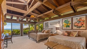 A bedroom with two beds, a piano, and a view of the ocean. - Fabulous Ocean Views with Mauna Kea Resort Access (Waimea)