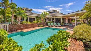 A swimming pool with lounge chairs and a covered patio area. - Fabulous Ocean Views with Mauna Kea Resort Access (Waimea)