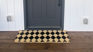 A dark-colored front door with a rectangular panel design, a doorbell, and a small window above it. - Discover Your Perfect Getaway: Cottage in the Heart of Horse & Bourbon Country! (Midway)