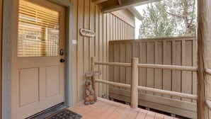 A wooden door with a window, a wooden sign that reads "WELCOME", and a small bear decoration. - Forest Ridge 2 Bedroom Home by RedAwning (Redmond)