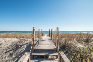 Walk along the boardwalk to the beach, where the ocean meets the shore.