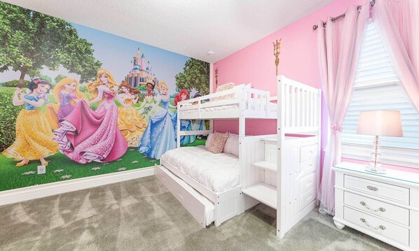 A child's bedroom with a bunk bed, a mural of Disney princesses, and pink walls.