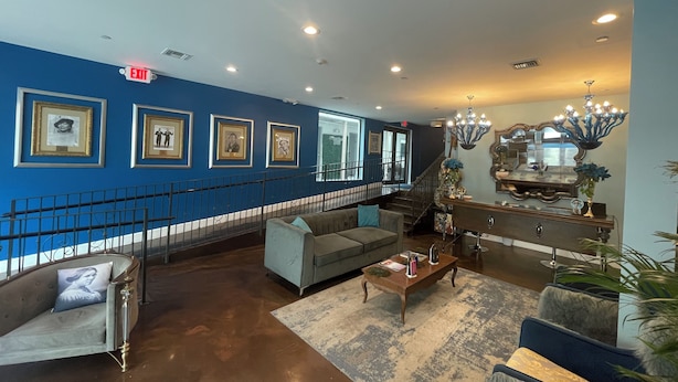 A spacious lobby with a blue accent wall, a staircase, and a chandelier. - Dunns Josephine Hotel (Miami)