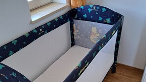 A child’s bunk bed with Winnie the Pooh and other characters on the mattress covers.