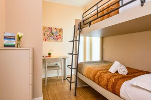 A bunk bed room with a desk, a ladder, a map on the wall, and a flower vase. - Appartamento Faelmo Luxury (Sirmione)