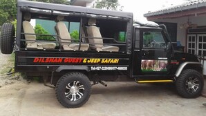 A black off-road vehicle with beige seats and a rear cargo area. - Dilshan Guest House (Polonnaruwa)