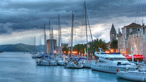 A marina with multiple sailboats docked, a historic building with a tower, and a calm waterfront. - Villa Lodi - new modern villa  few steps from beach with heated pool (Kaštel Štafilić)