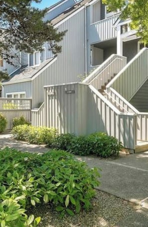 A residential building with a staircase leading to the entrance.