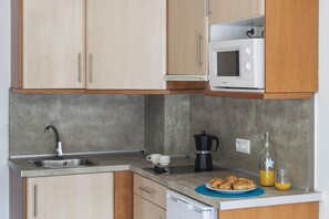 Fridge, microwave, coffee/tea maker, cookware/dishes/utensils