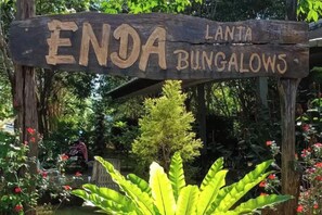 A wooden sign with the text 'ENDA LANTA BUNGALOWS' indicating a property name.