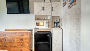 A compact kitchenette with a microwave, coffee maker, and a black refrigerator. - T08 - Schooner @ Trollers Lodge (Depoe Bay)