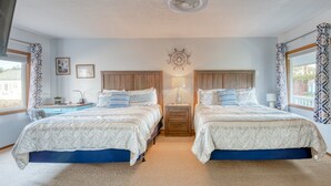 A bedroom with two beds, a nightstand, a wall clock, and a window with curtains. - T02 - Beacon @ Trollers Lodge (Depoe Bay)