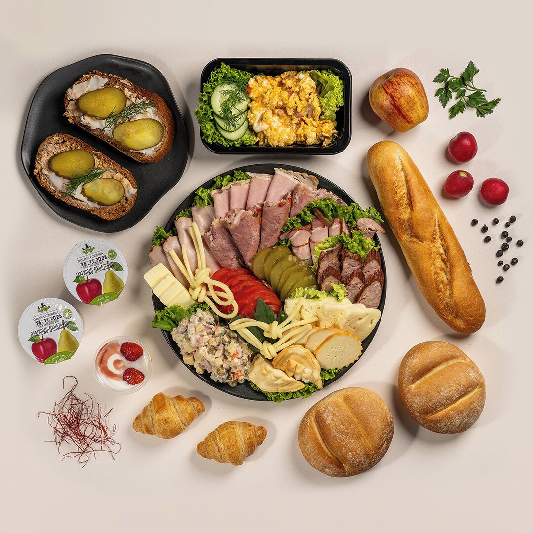 A variety of food items including bread, cheese, and fruits arranged on a table.