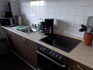 Fridge, microwave, coffee/tea maker, cookware/dishes/utensils