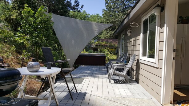 An outdoor patio with a grill, chairs, and a shaded area. - Explore Amador & Calaveras Counties. Kirkwood 45 minutes away. (West Point)