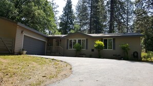 A single-story house with a garage, a covered porch, and a small front yard. - Explore Amador & Calaveras Counties. Kirkwood 45 minutes away. (West Point)
