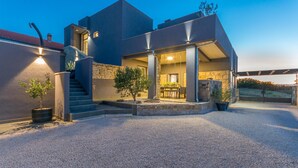 A modern house with a stone facade, a covered patio, and a gravel driveway. - Pet friendly home in Zagrad (Zagrad)