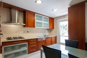 Enjoy meals in the kitchen with an oven, dishwasher, and stainless steel range hood, and dine at the glass table.