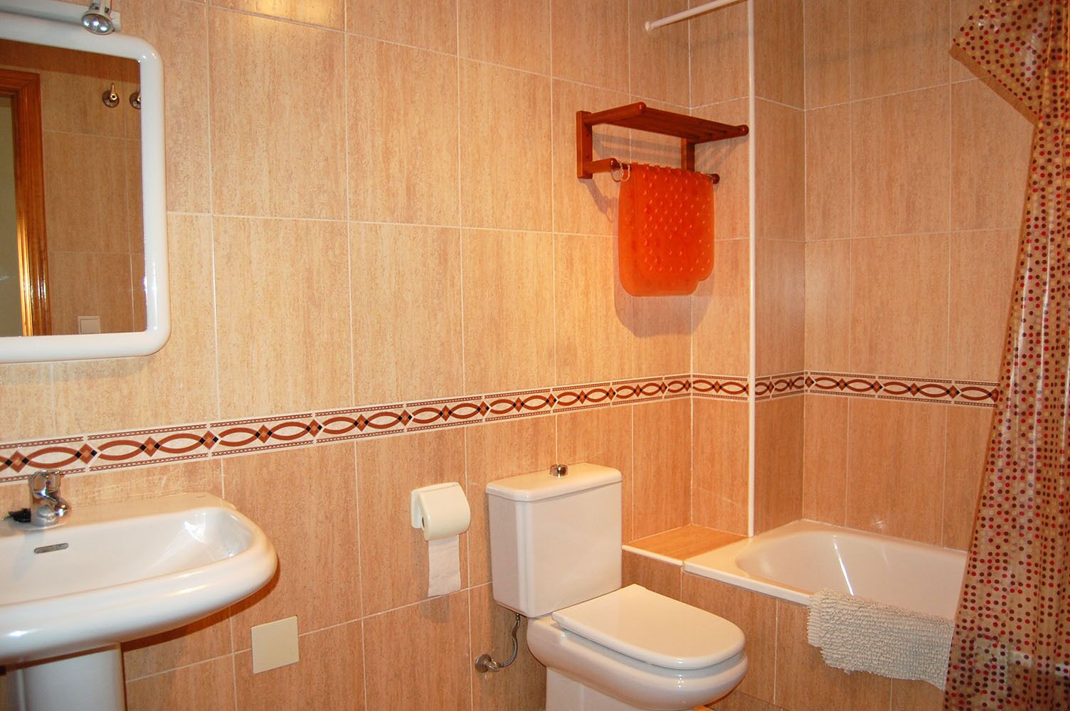 A bathroom with a sink, toilet, and bathtub.