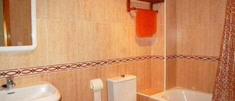 A bathroom with a sink, toilet, and bathtub.