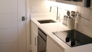 A modern kitchen with white cabinetry, a stainless steel microwave, and a dishwasher. - Ion spacious above garage apartment in quiet neighborhood. High ceilings! (Mt Pleasant)