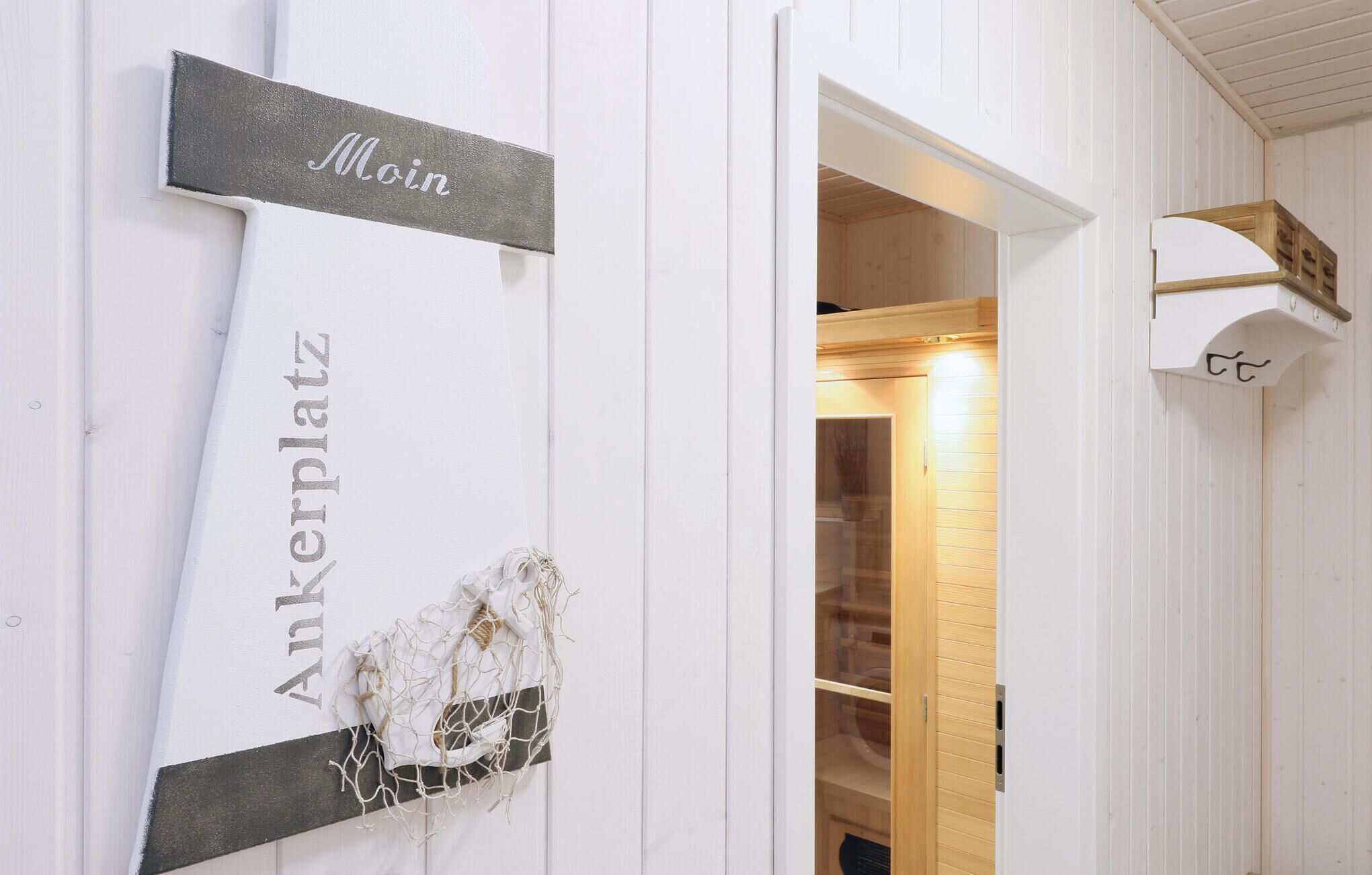 A white interior with a sign reading "Ankerplatz" and a partially visible door leading to a room.