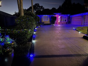 A driveway with decorative lights and a garage door.