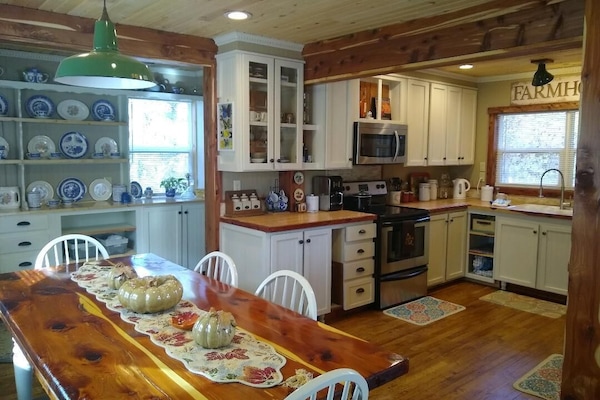 stovetop, indoor, oven, microwave, indoor dining, dining table, kitchen visible