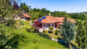 A house with a red-tiled roof, a small garden, and a solar panel on the roof. - Nice home in Varazdin Breg with sauna (Varazdin Breg)
