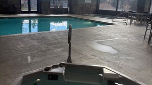 An indoor swimming pool with clear views of the sky through large windows, a spa rules sign, and a hot tub area. - Peaceful cozy place on the river with great views (Winter Park)
