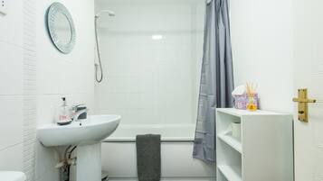Combined shower/bathtub, towels, toilet paper
