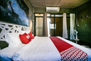 A hotel room with a large bed, a galaxy-themed wall mural, and a modern design.